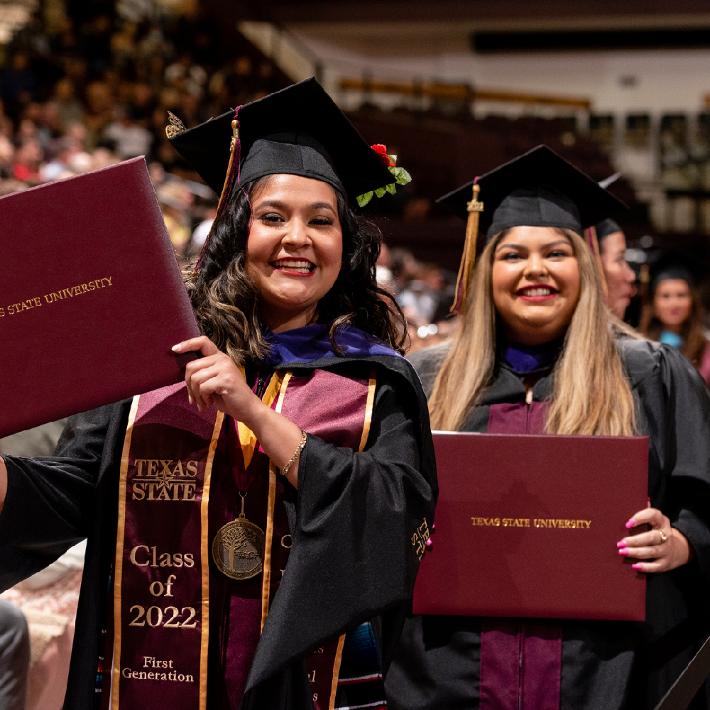 Graduates posing with diplomas